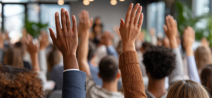 audience raising hands in a meeting four engagement participation discussion