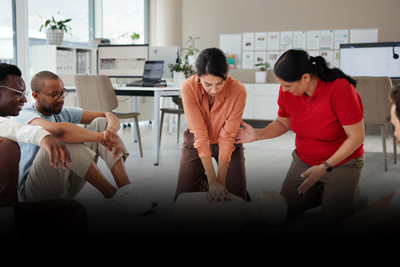 individuals practicing CPR techniques in a training session focused on emergency response skills