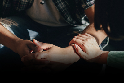 two hands clasped together in support suggesting connection empathy and trust in a caring relationship 5 steps to emotional healing